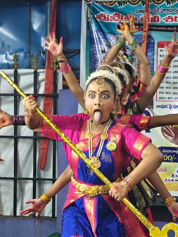 Kuchipudi dancer performing expressive Abhinaya with trident in Kali roopam